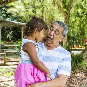 Australian Aboriginal Man Hugging His Grandaughter